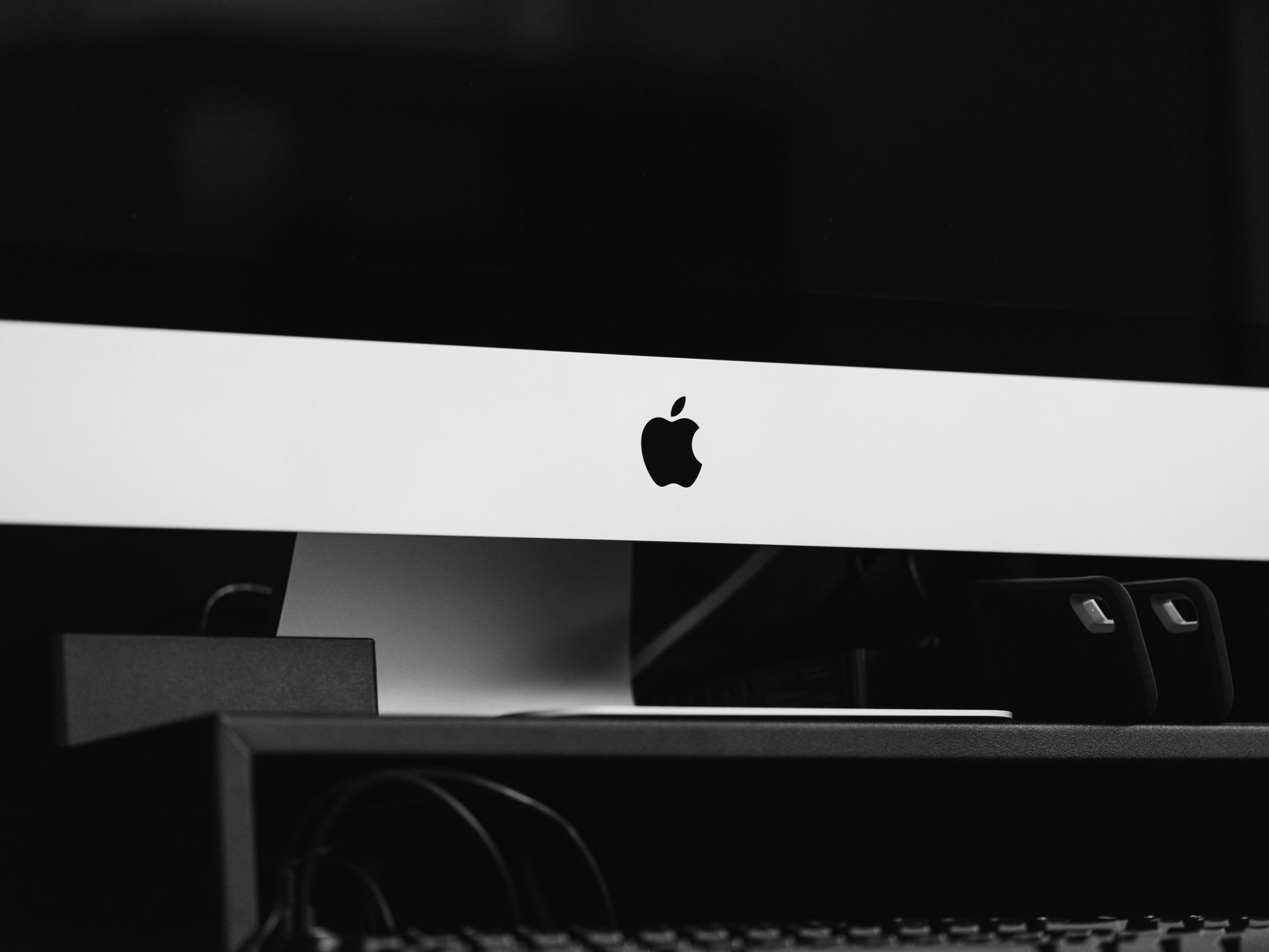 Sleek black and white minimalist desktop setup featuring modern technology in an indoor setting.