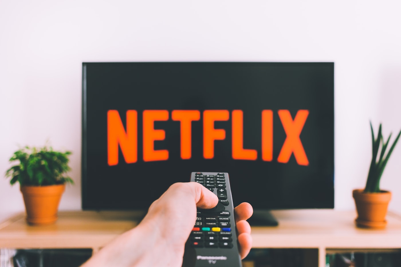 A living room television mounted above a media console