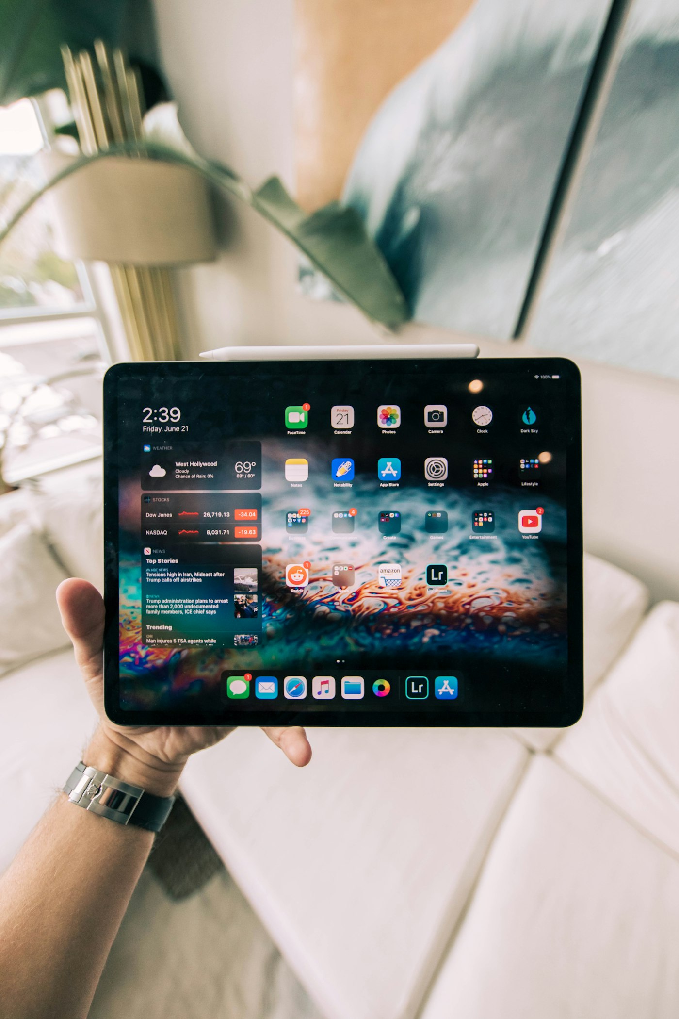 A tablet propped on a stand beside a keyboard