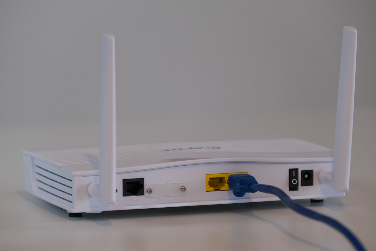 A home Wi-Fi router with status lights on a shelf